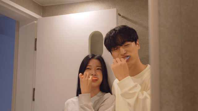 Couple brushing teeth together in bathroom