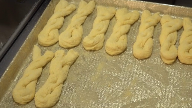 Preparing twisted donut dough on a tray