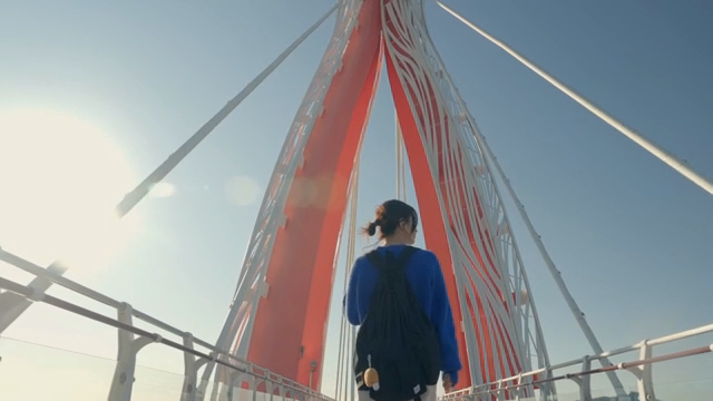 Woman walking on a scenic bridge