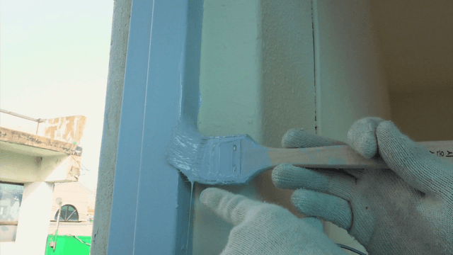 Delicate blue brush painting on a window frame