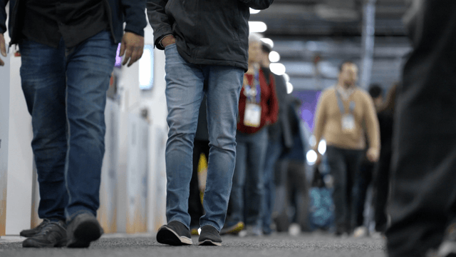 People walking through a crowded exhibition
