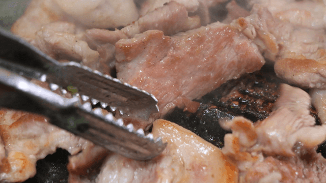Grilling pork on a hot pan