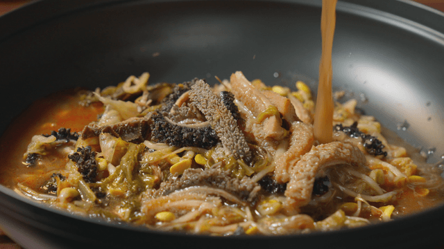 Beef tripe soup being poured