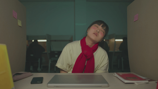 Female student stretching out of frustration in the study room