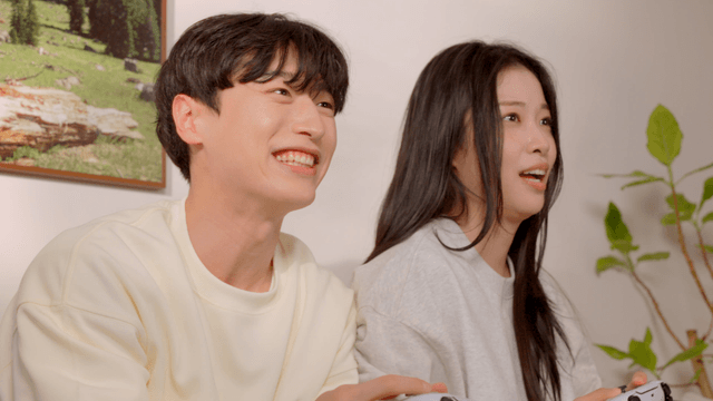 Couple playing console game on sofa