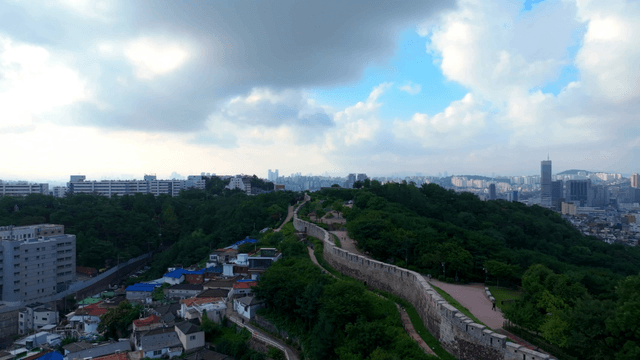 Cityscape with a historic wall and greenery