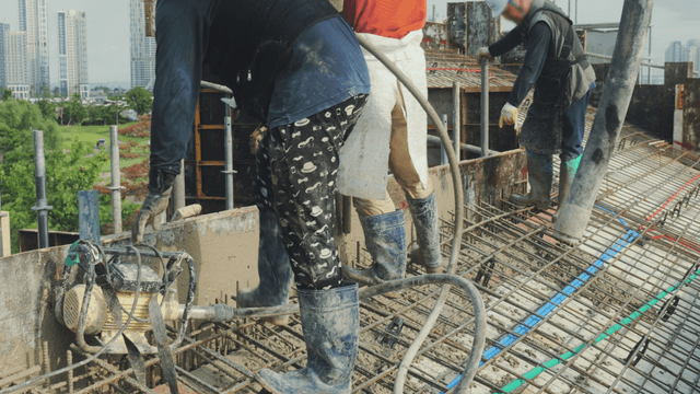 Construction workers pouring concrete