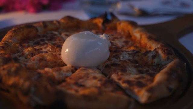Pizza with burrata cheese on top