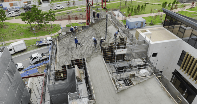 Construction workers pouring concrete