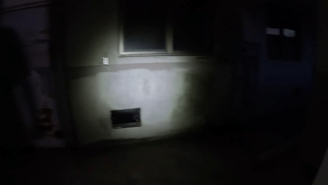 Dimly lit corridor with rusty doors