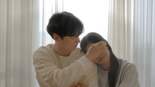 Couple resting by cozy window with gentle lean