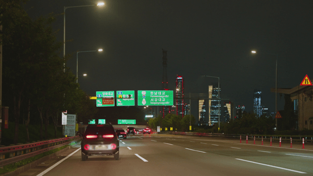 Night highway with a view of the Seoul city skyline
