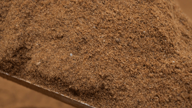 Pile of brown soil scooped by shovel