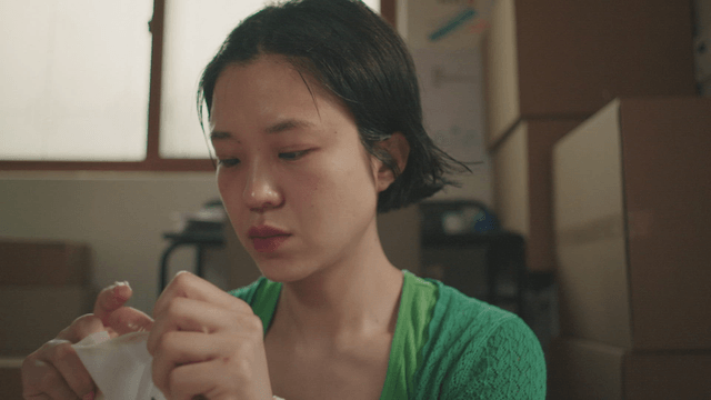 Woman applying a face mask at home