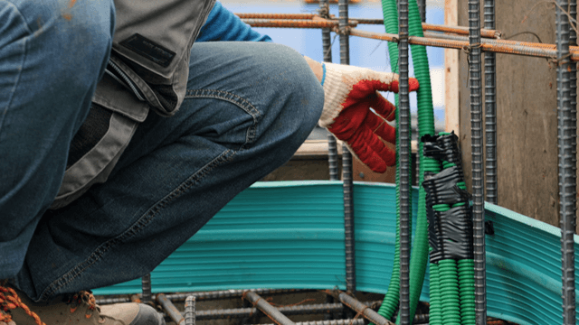 Construction worker handling cables
