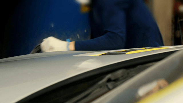 Car hood being polished in a workshop