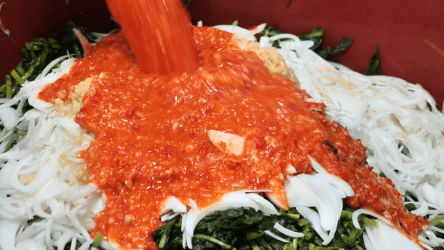 Mixing ingredients for kimchi preparation