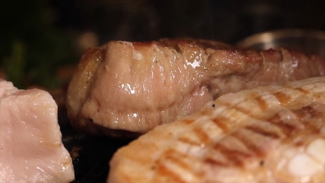 Grilled meat sizzling on a hot grill