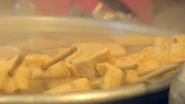Fish cake skewers boiling in broth