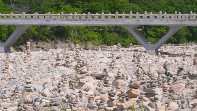 Stone towers stacked before neat stone bridge