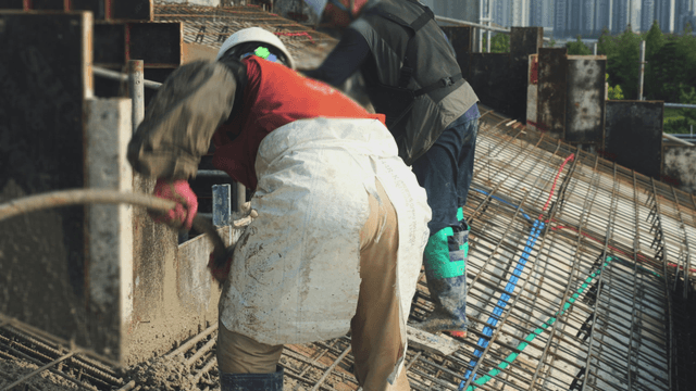 Construction workers pouring concrete