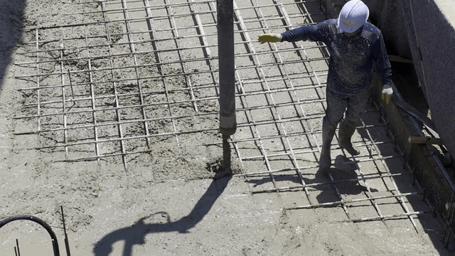 Construction workers pouring concrete