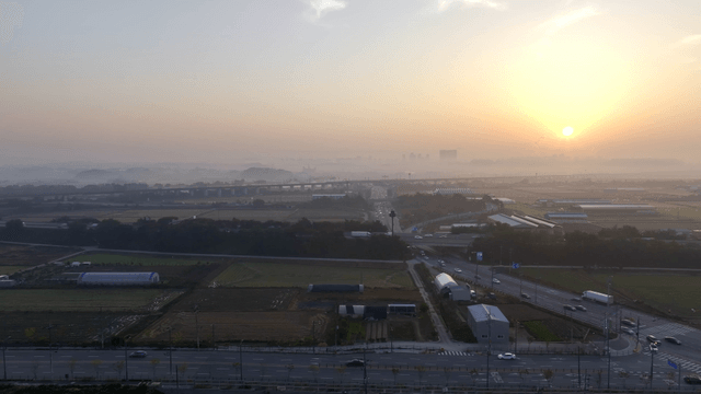 Sunrise over a misty rural landscape