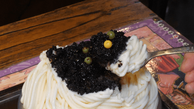 Spoonful of shaved ice with black topping
