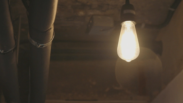 A glowing light bulb in a dim space
