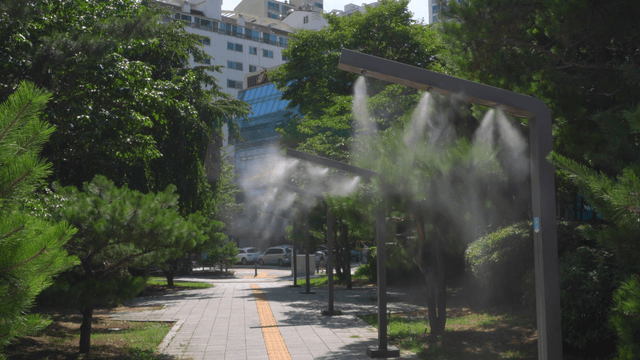 A city park with misting systems on a sunny day