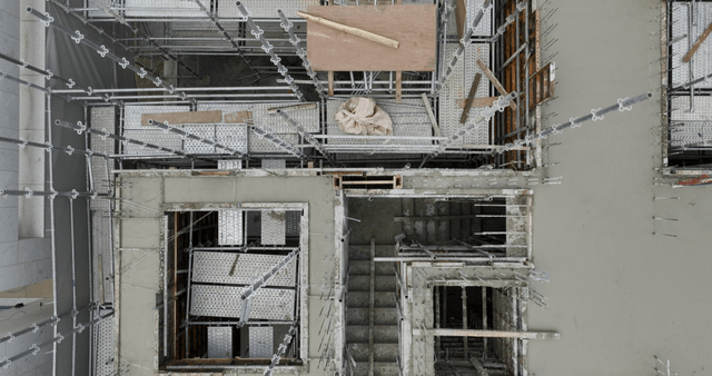 Construction site with scaffolding and worker