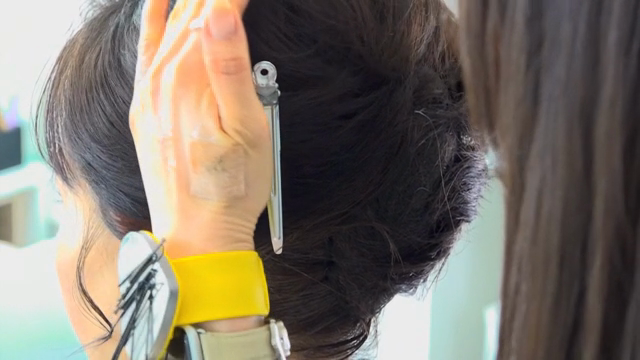 Hair being styled with a comb and clip