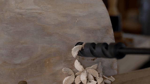 Spiral drill precisely boring a hole in wood