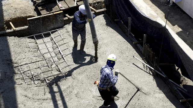 Construction workers pouring concrete