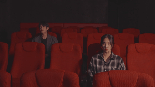 Two audience members sitting in a theater