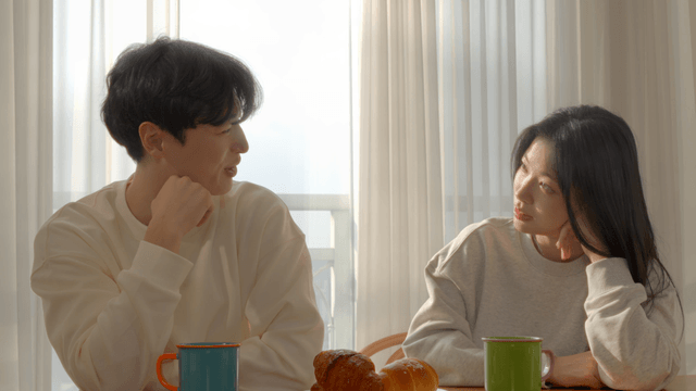 Couple talking at breakfast table in the morning light