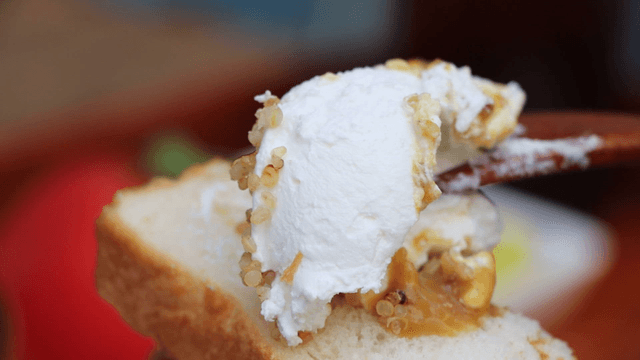 Yogurt spread on bread with a spoon