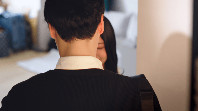 Couple sharing flowers and a warm hug at home
