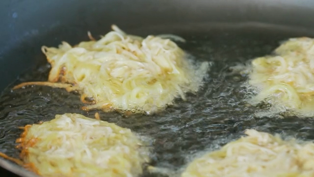 Potato pancakes frying in a pan