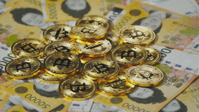 Bitcoin coins on Korean won bills