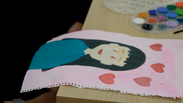 A painting of a person with hearts