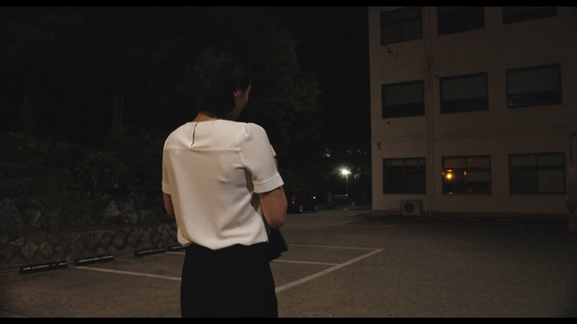 Woman checking acceptance letter at night with joy