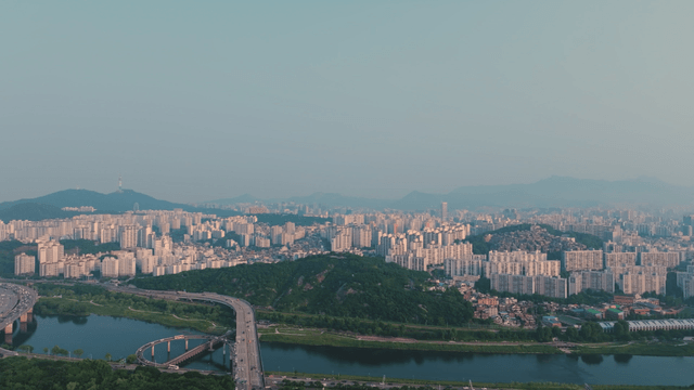 Wide cityscape with river and mountains