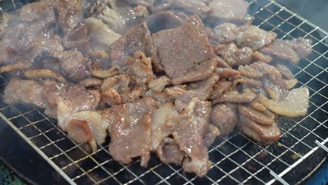 Grilled meat sizzling on a barbecue