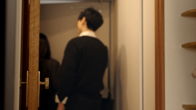 Smiling couple stepping out of cozy home entrance