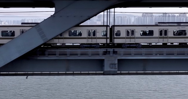 Train crossing a bridge over a river