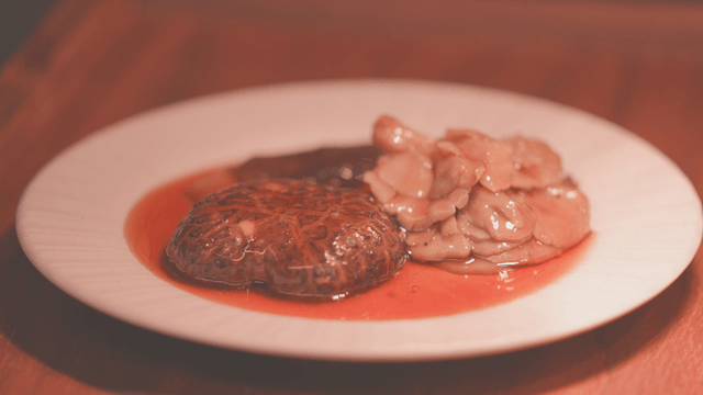 Gourmet mushroom dish with sauce on white plate