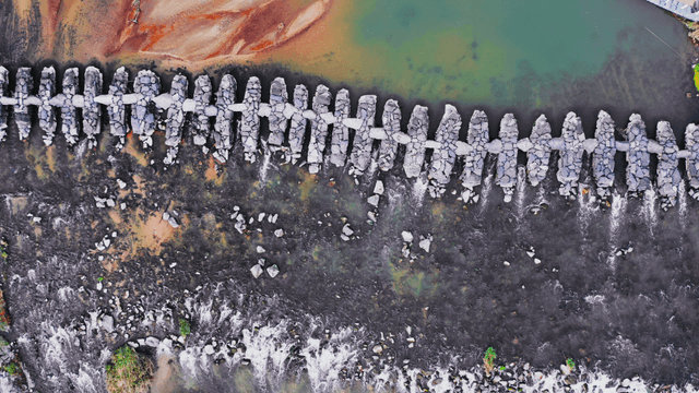 Aerial view of a stone bridge over river stream
