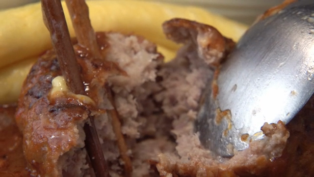 Slicing a juicy hamburger steak