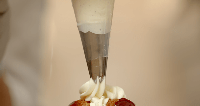 Cream piped onto dessert